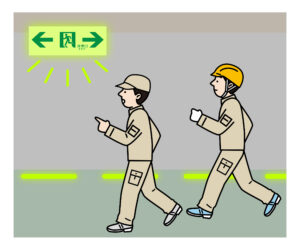 蓄光誘導標識を見て避難する人